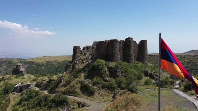 Aerial view of the historic medieval Amberd Fortress in Armenia on a sunny summer day under a blue sky. Spring scene, shot with a drone