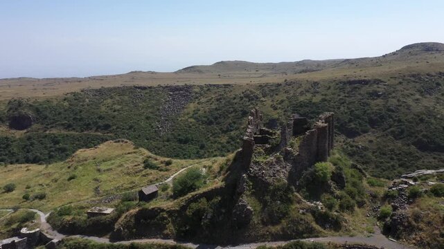 Aerial view of the historic medieval Amberd Fortress in Armenia on a sunny summer day under a blue sky. Spring scene, shot with a drone