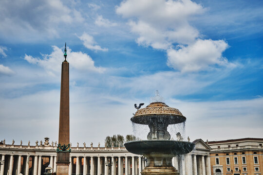 the iconic Vatican Obelisk (37 AD) and one of the twin fountains located in St. Peter's Square (Piazza San Pietro) within Vatican City, Rome, Europe 