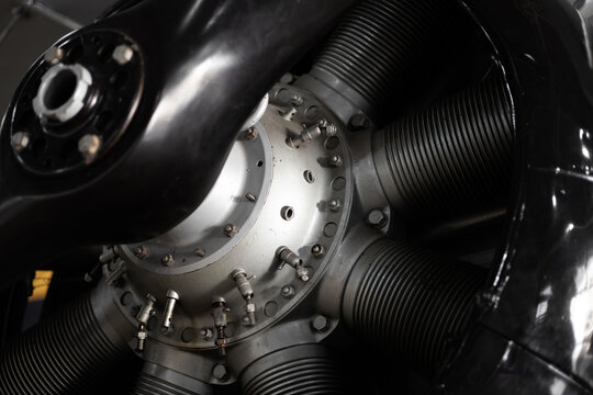 Detailed photograph of a vintage aircraft propulsion system featuring a radial engine and propeller.