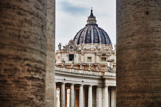 The iconic dome of St. Peter's Basilica (4th century), viewed from the colonnade of St. Peter's Square, Vatican City, Rome, Italy, Europe 