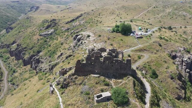 Aerial view of the historic medieval Amberd Fortress in Armenia on a sunny summer day under a blue sky. Spring scene, shot with a drone
