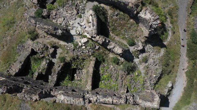 Aerial view of the historic medieval Amberd Fortress in Armenia on a sunny summer day under a blue sky. Spring scene, shot with a drone