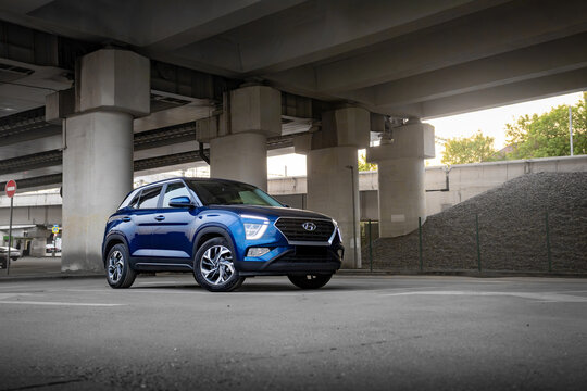 Blue Hyundai Creta SUV in urban setting on asphalt road. Modern crossover with stylish design and city atmosphere. Concept of mobility, comfort, travel, and everyday lifestyle.