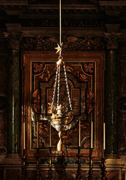 decorative incense burner (also known as a thurible or sanctuary lamp) hanging in front of an altar in St. Peter's Basilica in Vatican City, Rome, Europe 