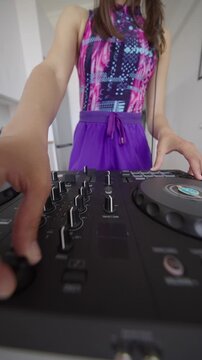 Confident female DJ creates energetic colorful live stream