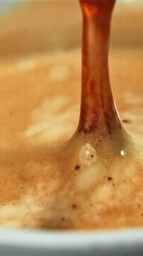 Falling drop in a cup of coffee. Filmed on a high-speed camera at 1000 fps. High quality FullHD footage