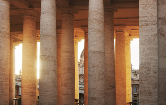 The sunlit columns of the colonnade in St. Peter's Square in Vatican City, Rome, Italy, Europe 