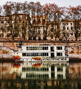 disused boat docked on the Tiber River in Rome, Italy, located between St. Peter's Basilica and the Trastevere area, Europe 