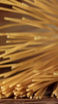 Spaghetti falling on a wooden table. Filmed on a high-speed camera at 1000 fps. High quality FullHD footage