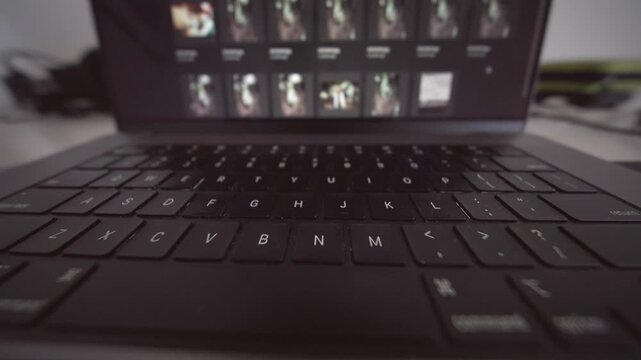 Freelance photographer examining image thumbnails in creative space
