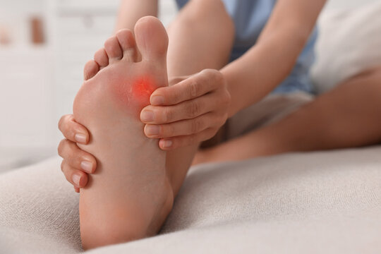 Woman with callus on her foot at home, closeup