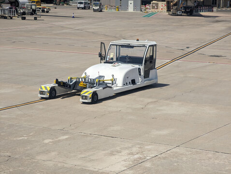 Electric towbarless aircraft tractor for sustainable ground handling operations at airport. aircraft tractor, support equipment, aviation, pushback, towing, eco-friendly, zero emission, tarmac.