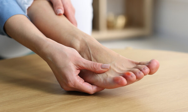 Woman with callus on her toe at home, closeup