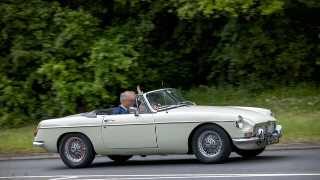 Milton Keynes,Bucks,UK - May 21st 2026:  1969 white MGB  classic car driving on a British road
