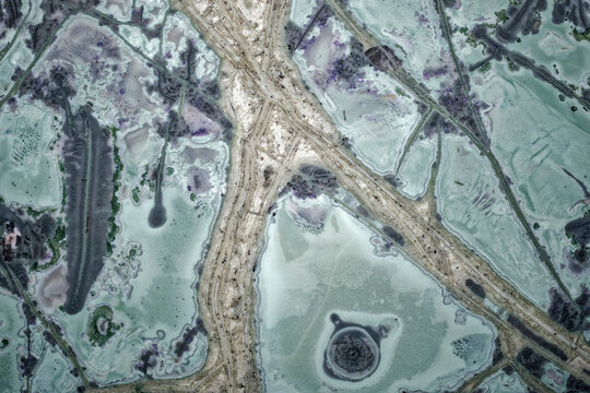 Macro of unique tinguaite rock polished surface from Khibiny with orbicular structures, albite veins and intricate patterns from magma crystallization, 15 mm field of view