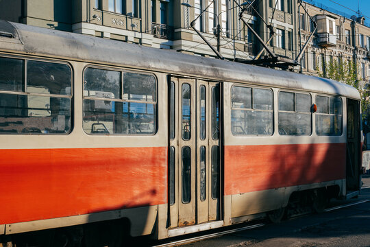 Kyiv, Ukraine - May 5, 2026: Red retro tram on Kontractova square - Podil district. Red tram is popular touristic transport and attraction. Against of the residential complex Podol Prestige.