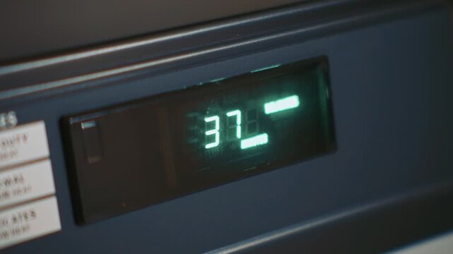 Dryer remaining cycle time displayed on digital screen in close up showing household appliance operation and drying program progress

