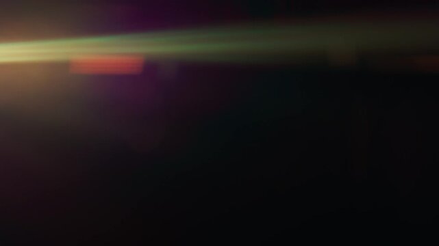 Purple anamorphic lens flares fading out into dark background