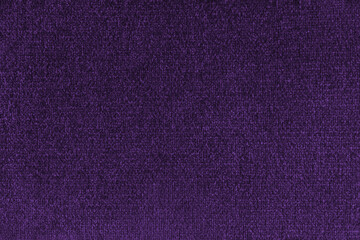 Fototapeta premium Close up, macro of purple fabric texture with soft velvet, fluffy woven surface, rich textile detail. Knitted jersey cloth background, backdrop, wallpaper for design, fashion or interior projects