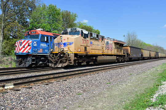 An eastbound Metra commuter train, bound for Chicago, passes a coal train paused for a signal in a western suburban Chicago location. 