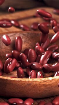 Bean grains fall into a wooden bowl. Filmed on a high-speed camera at 1000 fps. High quality FullHD footage
