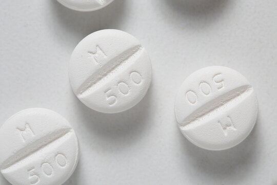 Metformin 500mg tablet type 2 diabetes treatment, white background, up close