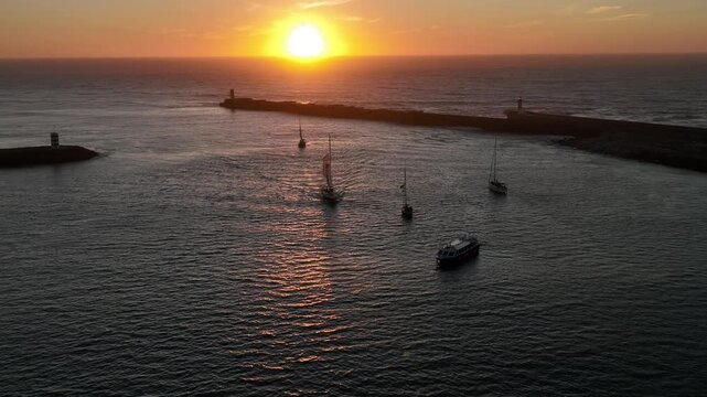 Aerial Cinematic View of Sailing Vessels at Sunset in Foz do Douro Porto Portugal Coast