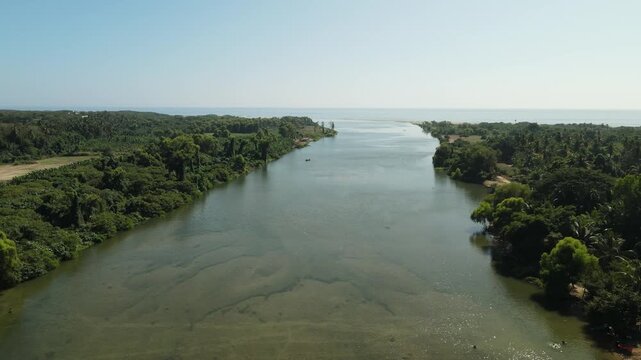 Cinematic Aerial View of a River Flowing Into the Pacific Ocean on the Oaxaca Coast Mexico