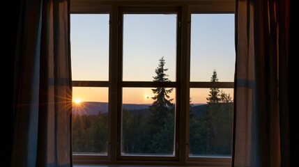 Fototapeta premium Window view of a serene sunset over a dense forest with pine trees