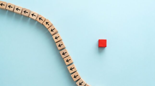 Bold red cube breaks formation of arrow-marked wooden blocks on a light blue background, symbolizing individuality, innovation, and stepping off the conventional path