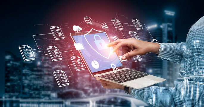 A person interacts with a laptop featuring digital security graphics, surrounded by data imagery in a vibrant urban night scene, emphasizing modern technology and cybersecurity. Ledger