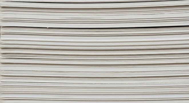 Close-up view of a stack of papers with horizontal lines.