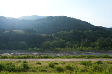 Naklejka premium Beautiful mountain river landscape with green forest in Japan.