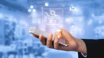 Obraz premium Hand Holding Smartphone with Digital Procurement Icons and Illustrations on Blue Background for E-commerce and Business Solutions. Bitwise.