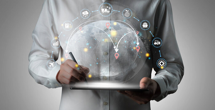 Businessman Engaging with Futuristic Digital Interface Featuring Globe, Location Pins, and Various Technology Symbols in a Professional Setting Haptic.