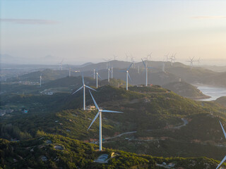 Wind turbines stand across the scenic hills of Pingtan in Fujian China during a clear sunset © AS_SleepingPanda