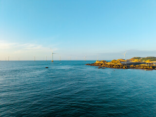 Obraz premium Offshore wind turbines stand in the sea near the rocky coast of Pingtan in Fujian China