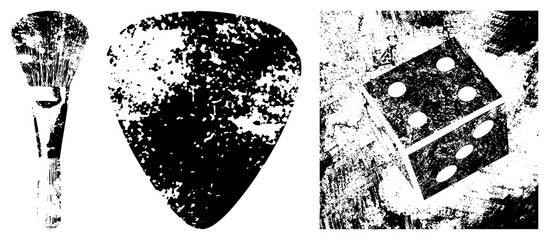 Obraz premium Edgy collection featuring a worn guitar pick, a weathered dice cube, and a grit textured paintbrush. These rough rock tools and game pieces feature a heavy stencil aesthetic for intense designs.
