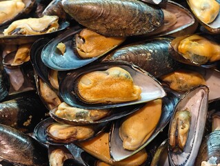 Close-up view of a pile of fresh raw mussels with open shells and meat © Robert