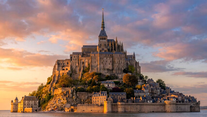 Mont Saint Michel abbey and village at sunset with dramatic clouds © erna