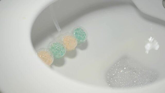 Cleaning products in toilet bowl during flushing process