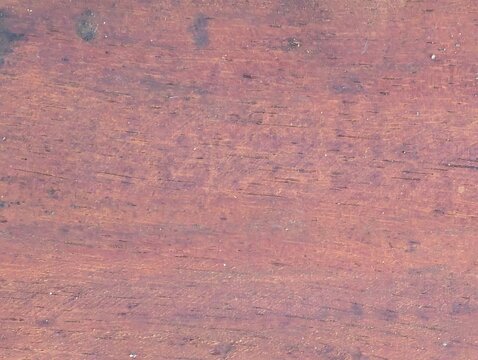 Natural Purpleheart or Ironwood Timber Texture with Detailed Grain
Description:
High-angle close-up of a natural wood plank texture with a distinct purplish-brown hue and detailed horizontal grain pat