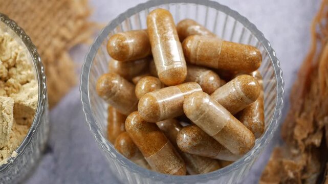 Herbal supplements in glass jar on table