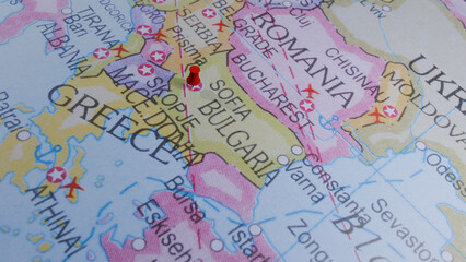 Obraz premium Close-up map of Eastern Europe, showing Greece and Balkan countries with a red pin in Macedonia.