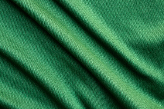 Green sports clothing fabric football shirt jersey texture close up