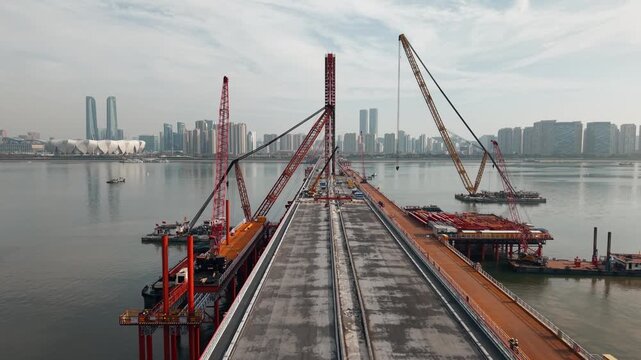 Bridge dismantling progress over river with large cranes and heavy equipment operations