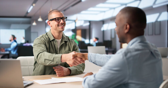 Two Professionals Shake Hands Sealing A Successful Corporate Job