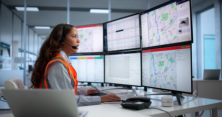 Young Woman At Emergency Center Calmly Handles Urgent 911 Calls © Andrey Popov