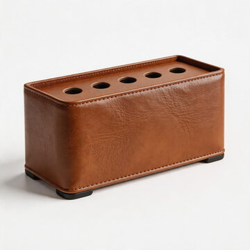 This is a rectangular brown leather pen holder with four holes for stationery, equipped with anti-slip feet, suitable for desk organization.